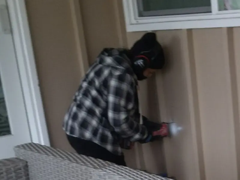 Professional electrician installing an exterior outlet in Breitung